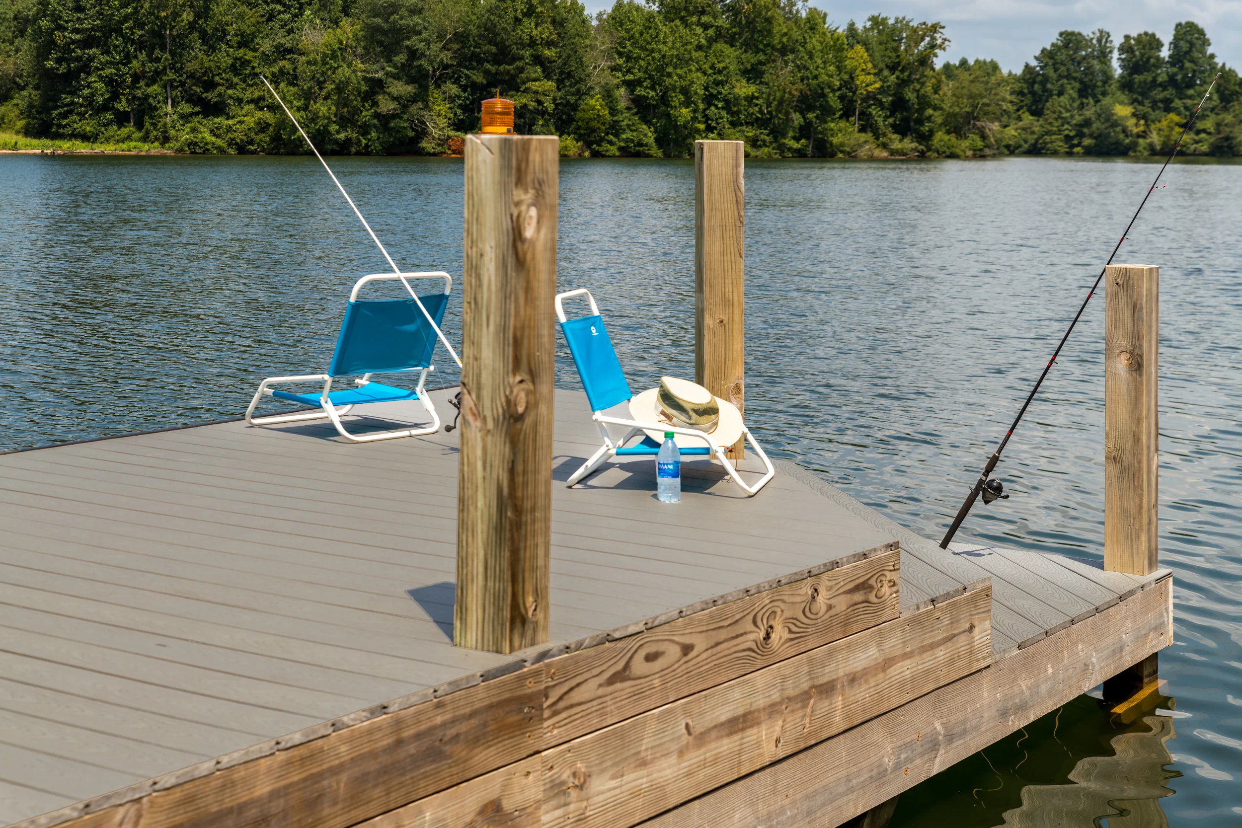 Chairs, american flags, fishing poles and swimming gear on a dock in Soddy Daisy, Tennessee.