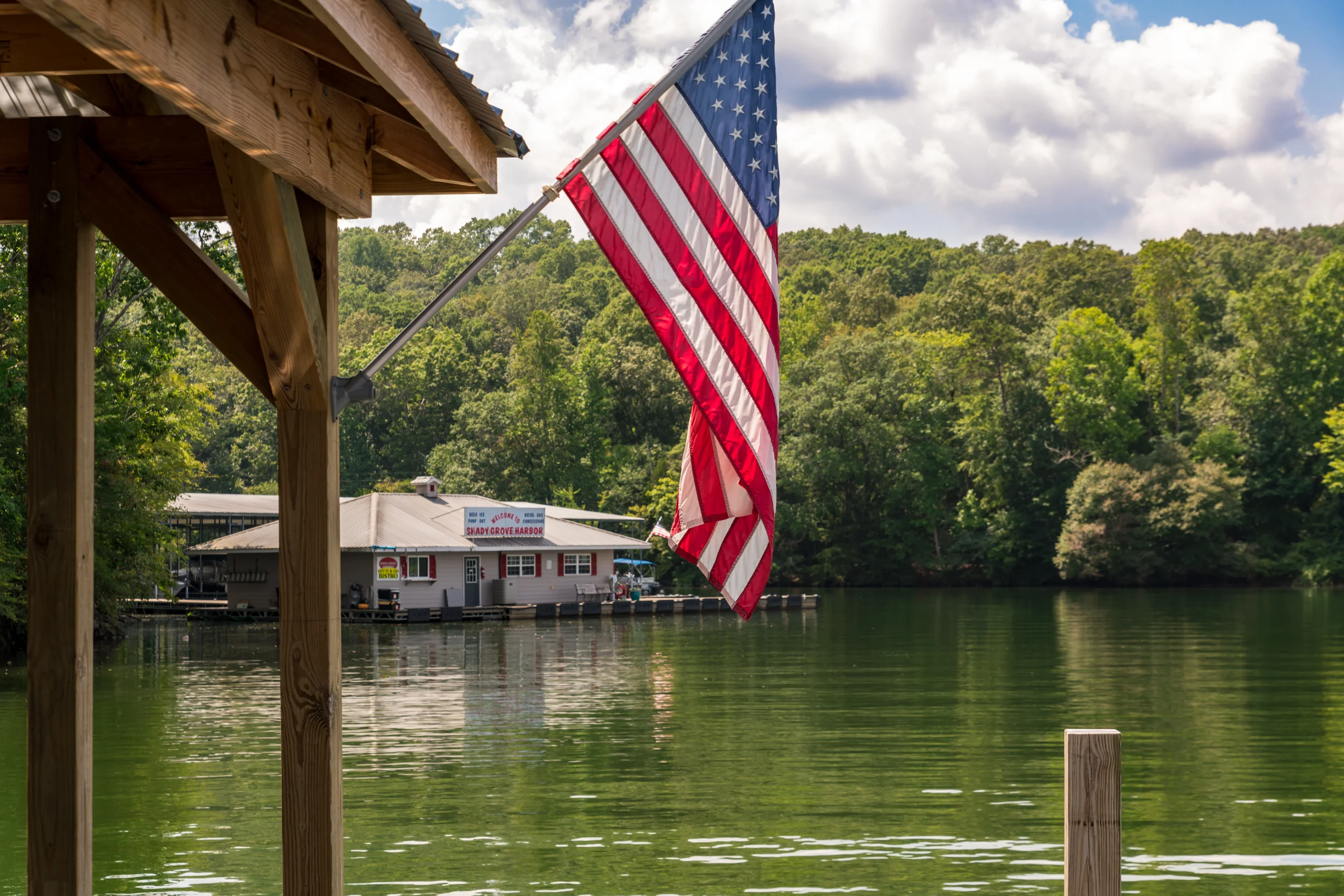 Chairs, american flags, fishing poles and swimming gear on a dock in Soddy Daisy, Tennessee.