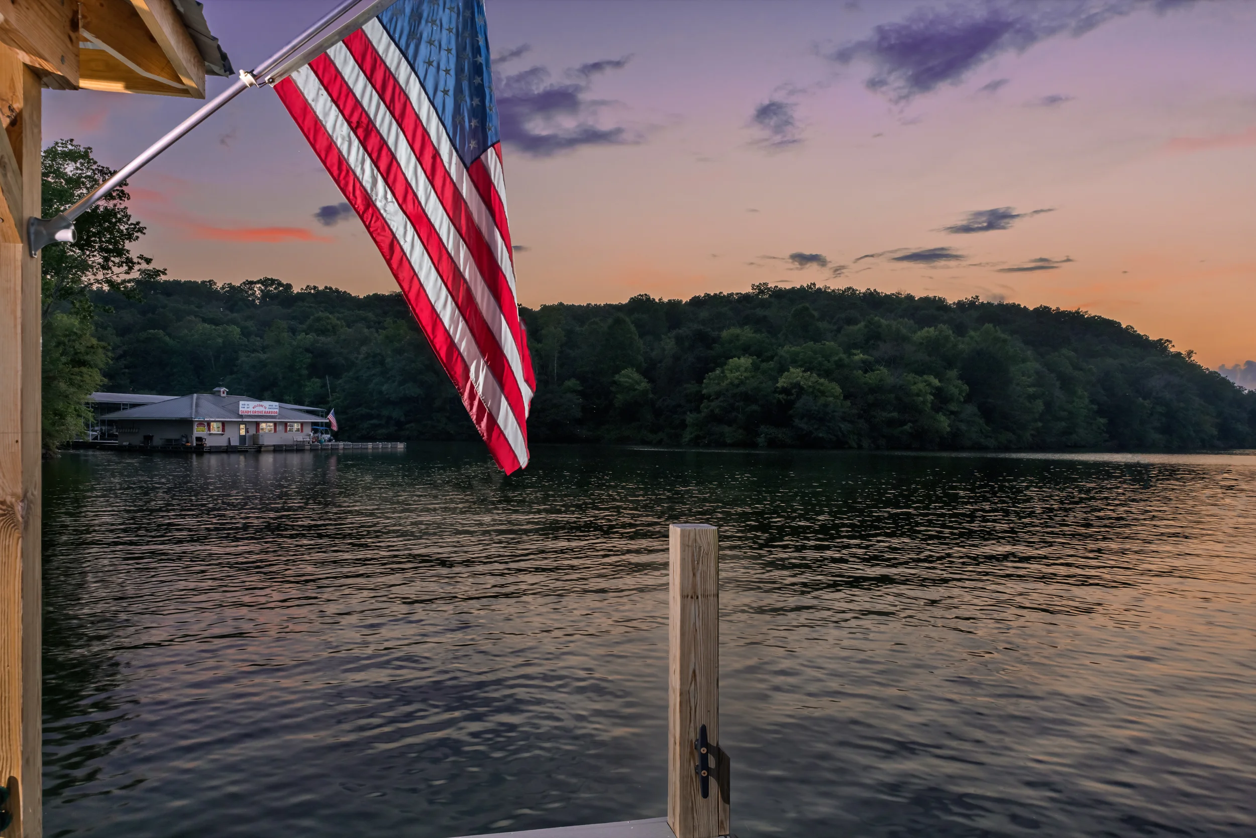 Chairs, american flags, fishing poles and swimming gear on a dock in Soddy Daisy, Tennessee.