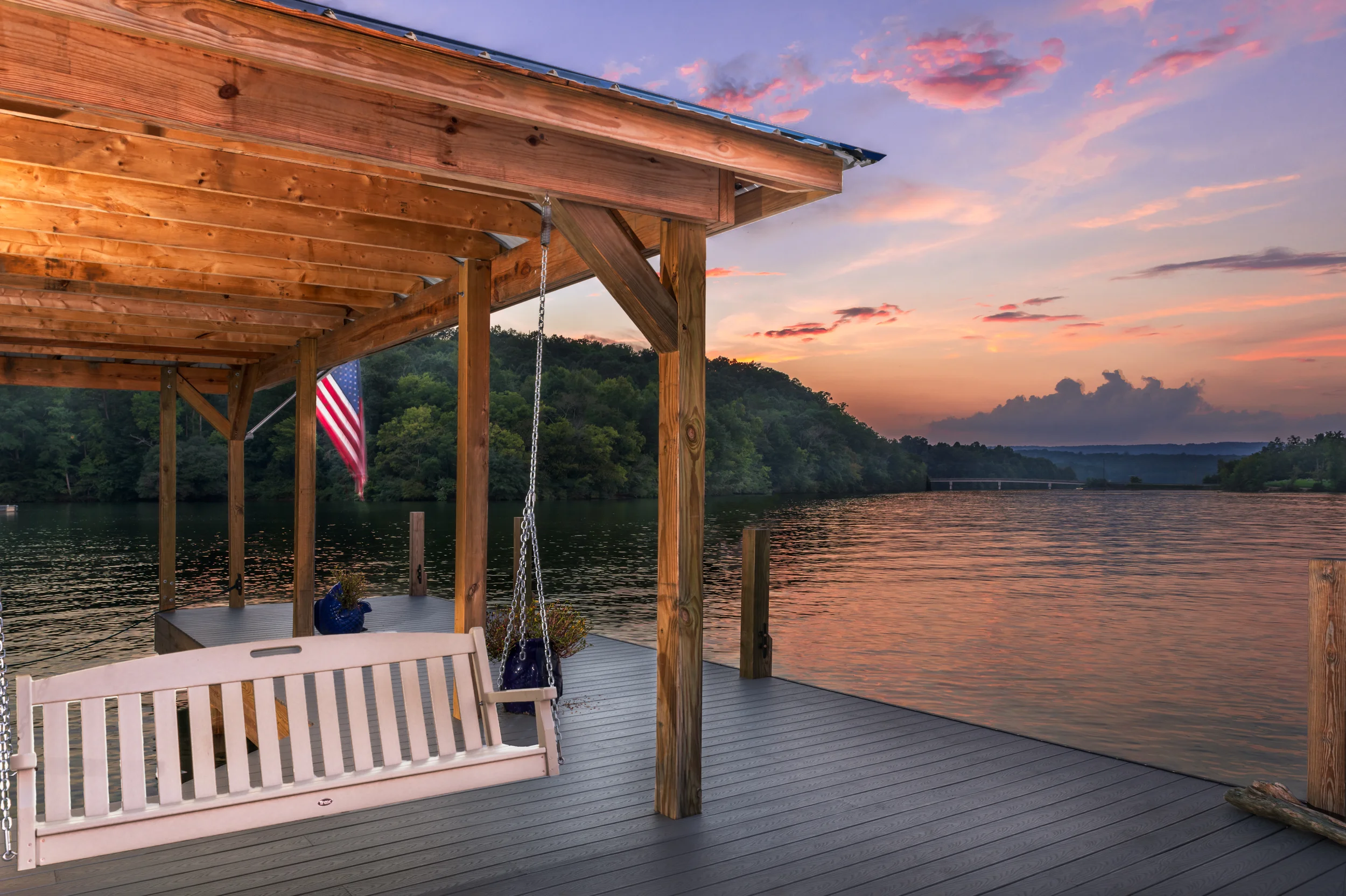 Chairs, american flags, fishing poles and swimming gear on a dock in Soddy Daisy, Tennessee.